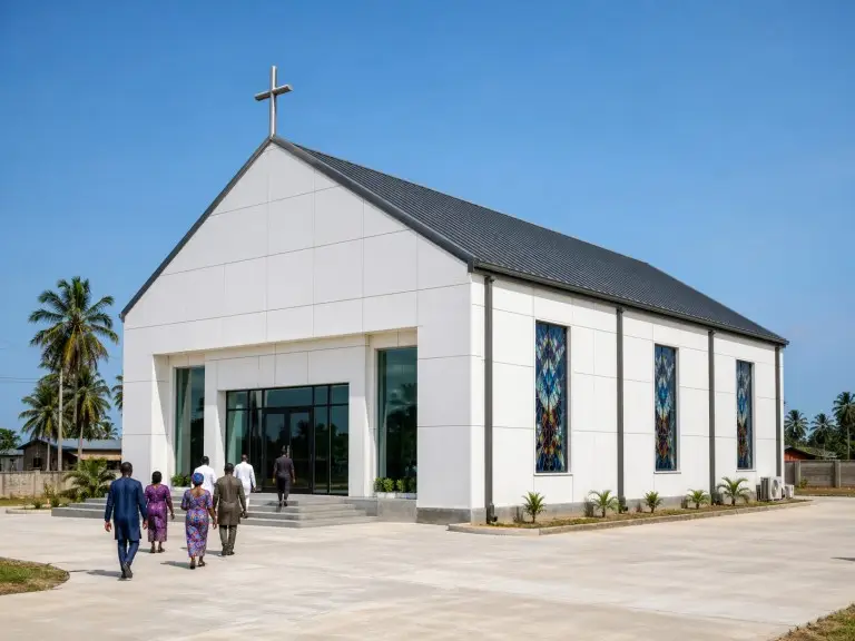 Steel church building — gabled sanctuary with white ACP panel facade and glazed entrance, Nigeria
