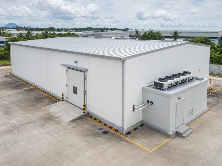 Prefab steel cold storage building — PU insulated panel envelope with specialist cold store door and refrigeration plant room