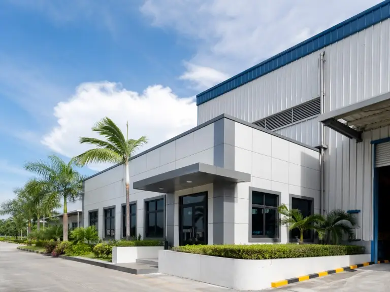 Metal building office wing — prefab steel administration block attached to industrial park warehouse, Vietnam