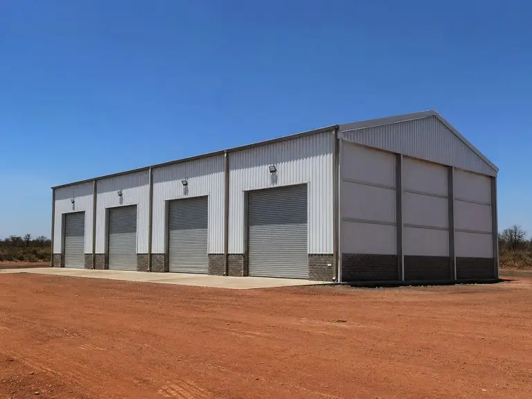 Prefab workshop buildings — modular multi-tenant steel workshop units with shared column grid, Sub-Saharan Africa
