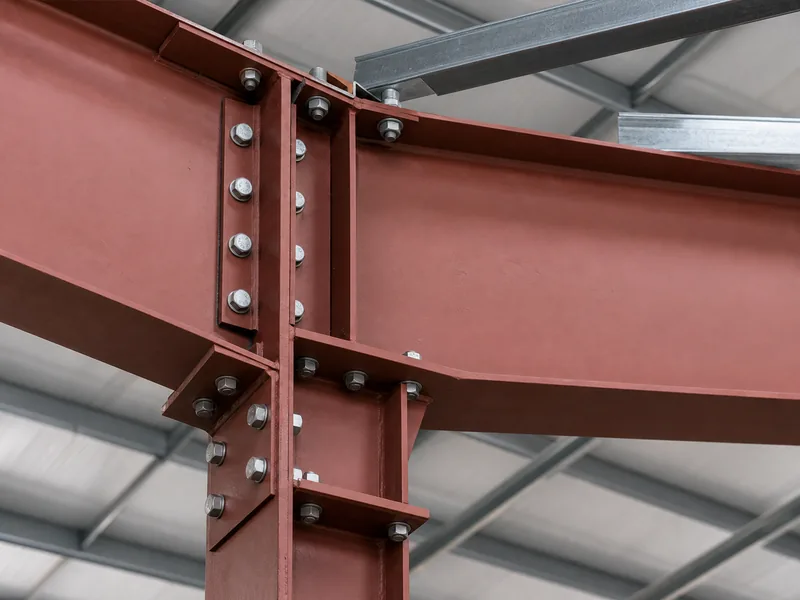 Close-up of a steel rigid frame haunch connection whose steel weight drives clearspan building cost 