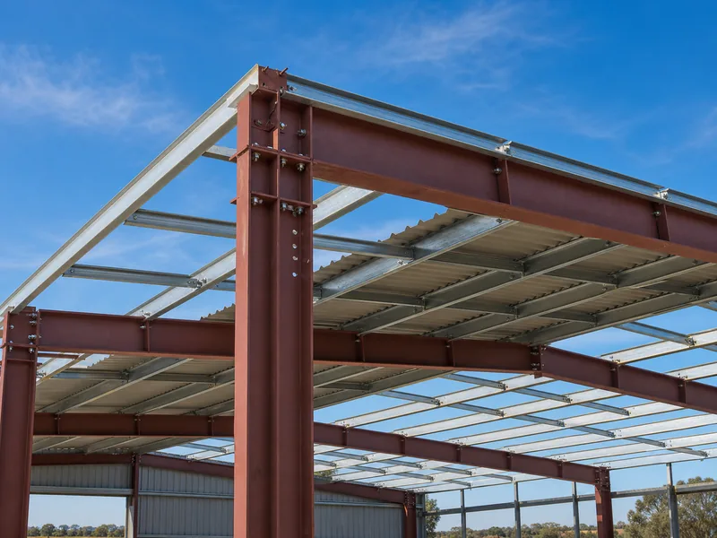 Column-free interior of a steel farm building with open storage bays