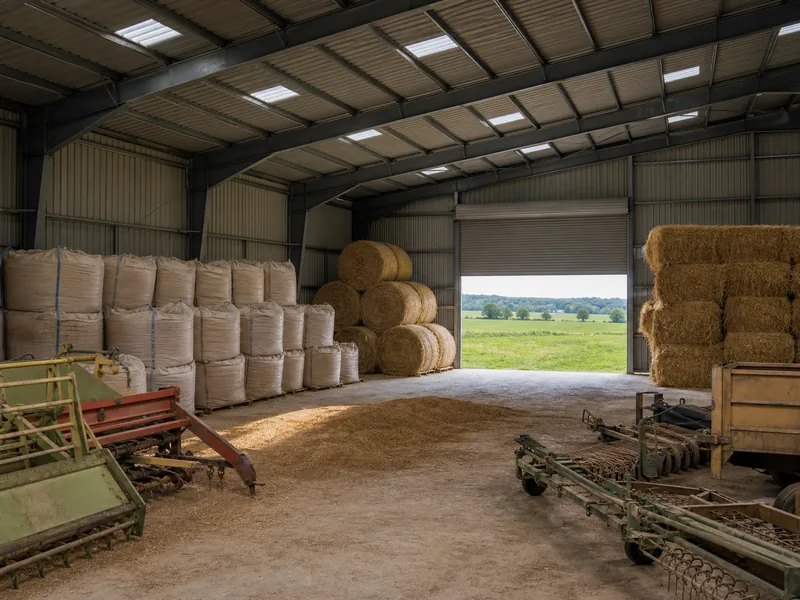 Grain and machinery stored inside a barn kept in genuine agricultural use