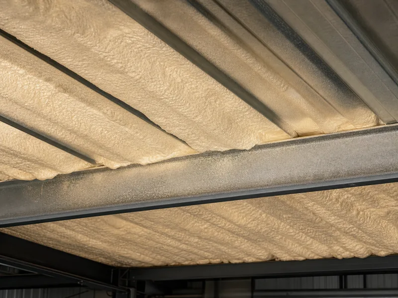 Closed-cell spray foam applied to the underside of a metal roof panel