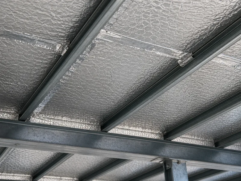 Double bubble foil keeping a metal roof panel free of condensation