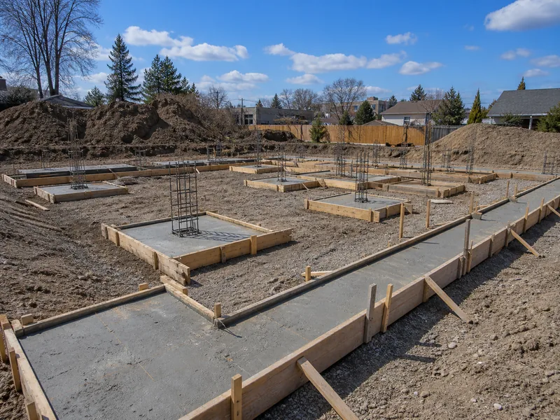 Spread footing pads and a strip footing trench on a building site