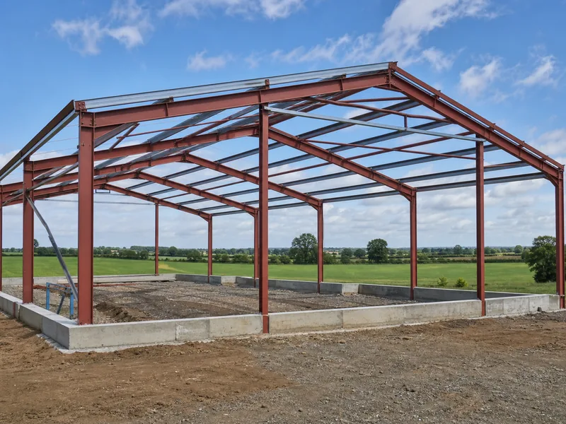 Steel frame of a new agricultural building under assembly on a farm